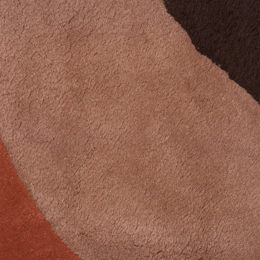 Ferm Living View Tufted Rug Red Brown Close-up of a textured brown fabric surface
