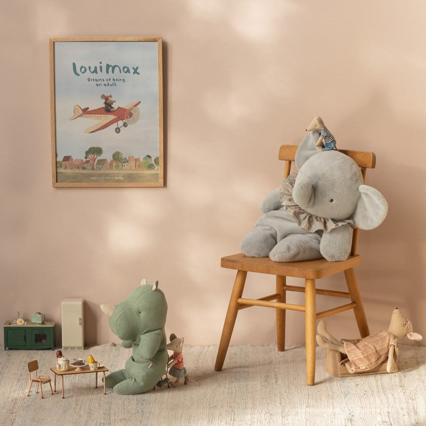 Children's room with plush toys and a framed picture on the wall.