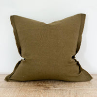 Thumbnail for Green pillow on a wooden surface with a white background