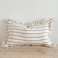 Thumbnail for Striped pillow with ruffled edges on a wooden surface against a light background