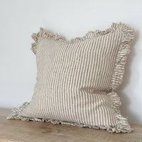 Thumbnail for Striped linen pillow with ruffled edges on a wooden surface against a light background