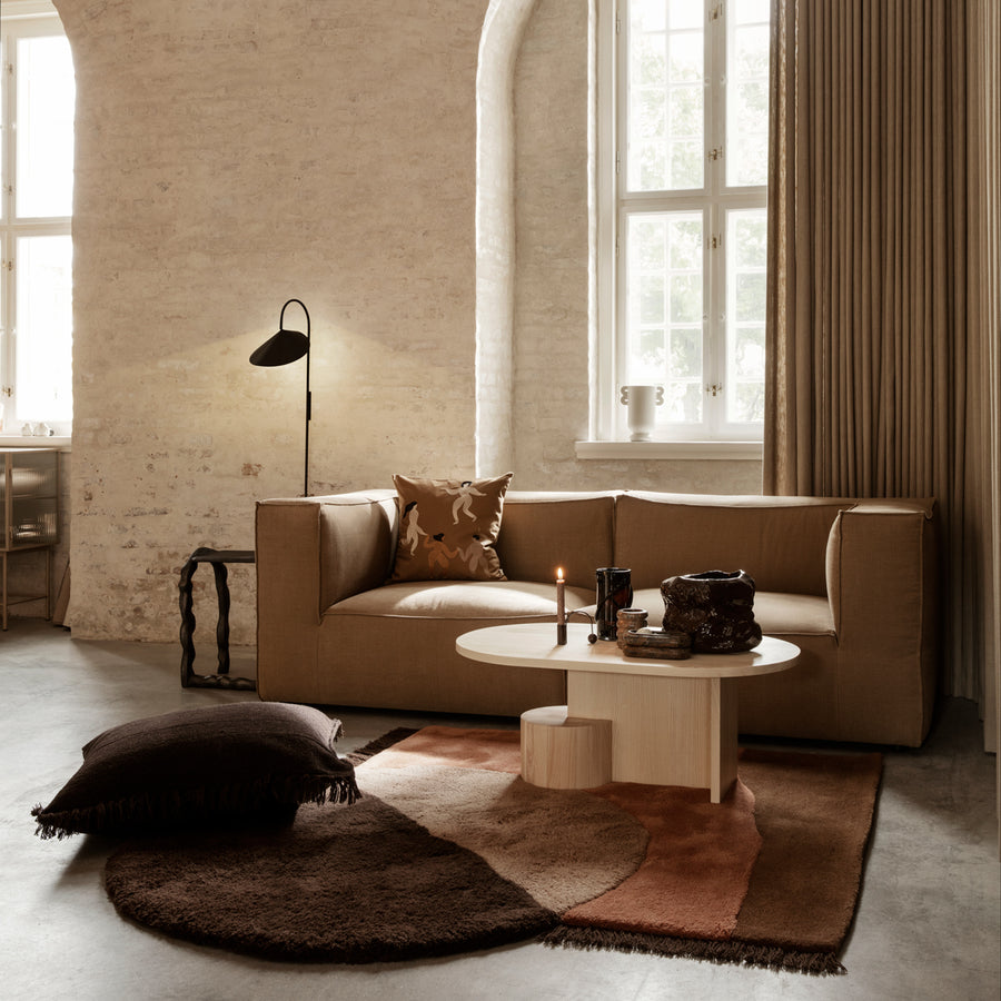 Ferm Living View Tufted Rug Red Brown Modern living room with a beige sofa, coffee table, and decorative pillows.