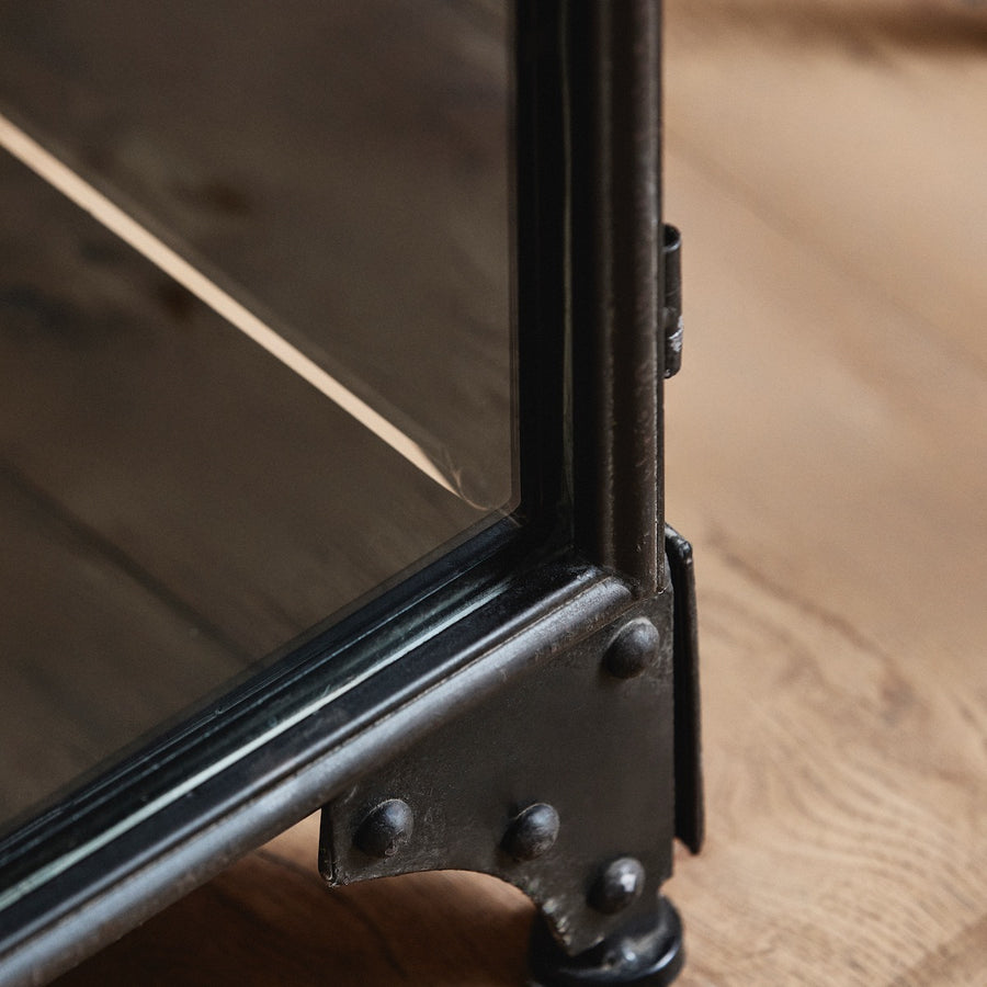 Close-up of a metal frame on a wooden surface