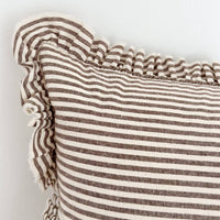 Thumbnail for Close-up of a brown striped linen cushion with ruffled edge on a light background