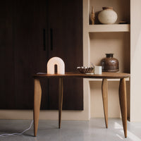 Thumbnail for Arch-shaped lamp on a wooden surface with a dark background
