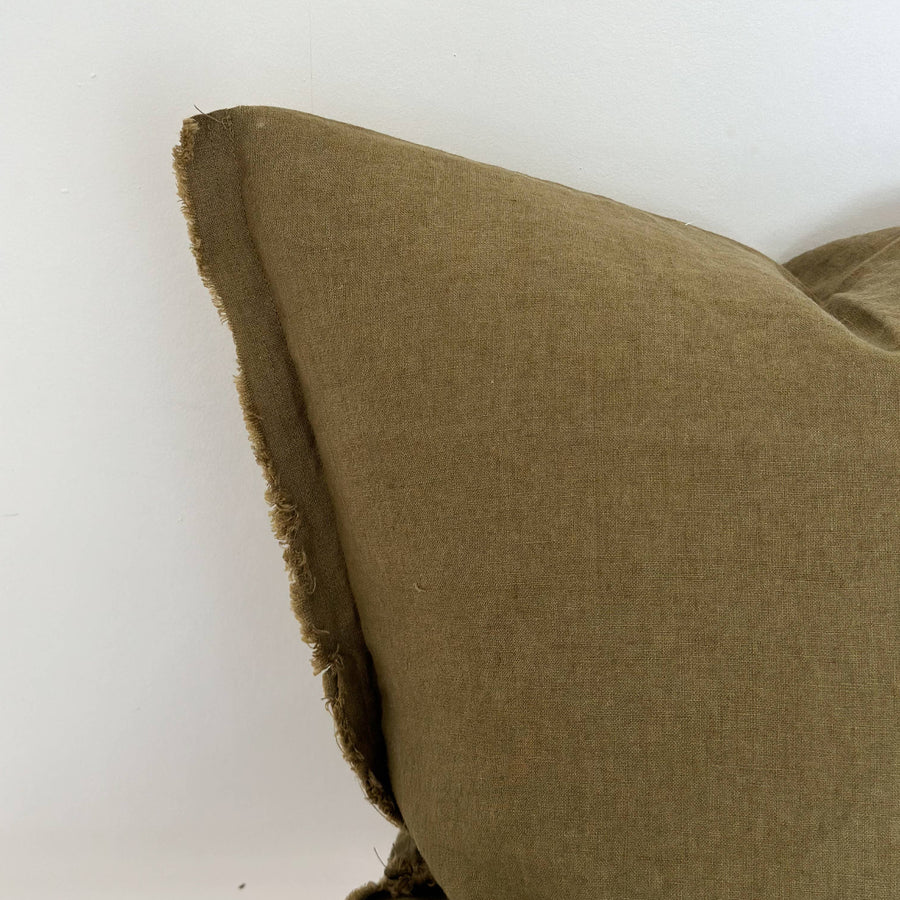 Close-up of a green linen pillow on a white background