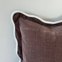 Thumbnail for Brown textured pillow with white piping on a light gray background