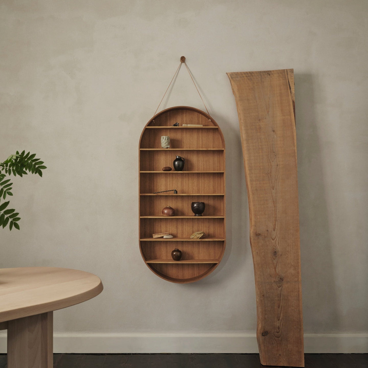 Wooden wall shelf with decorative items against a plain wall.