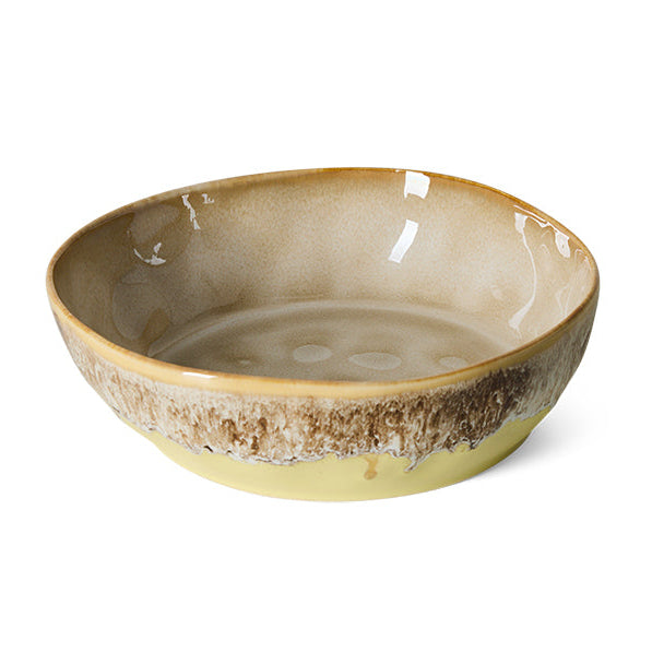 A handmade ceramic bowl with a glossy beige and brown glaze and a rustic, textured brown band around the rim, shown on a plain white background.