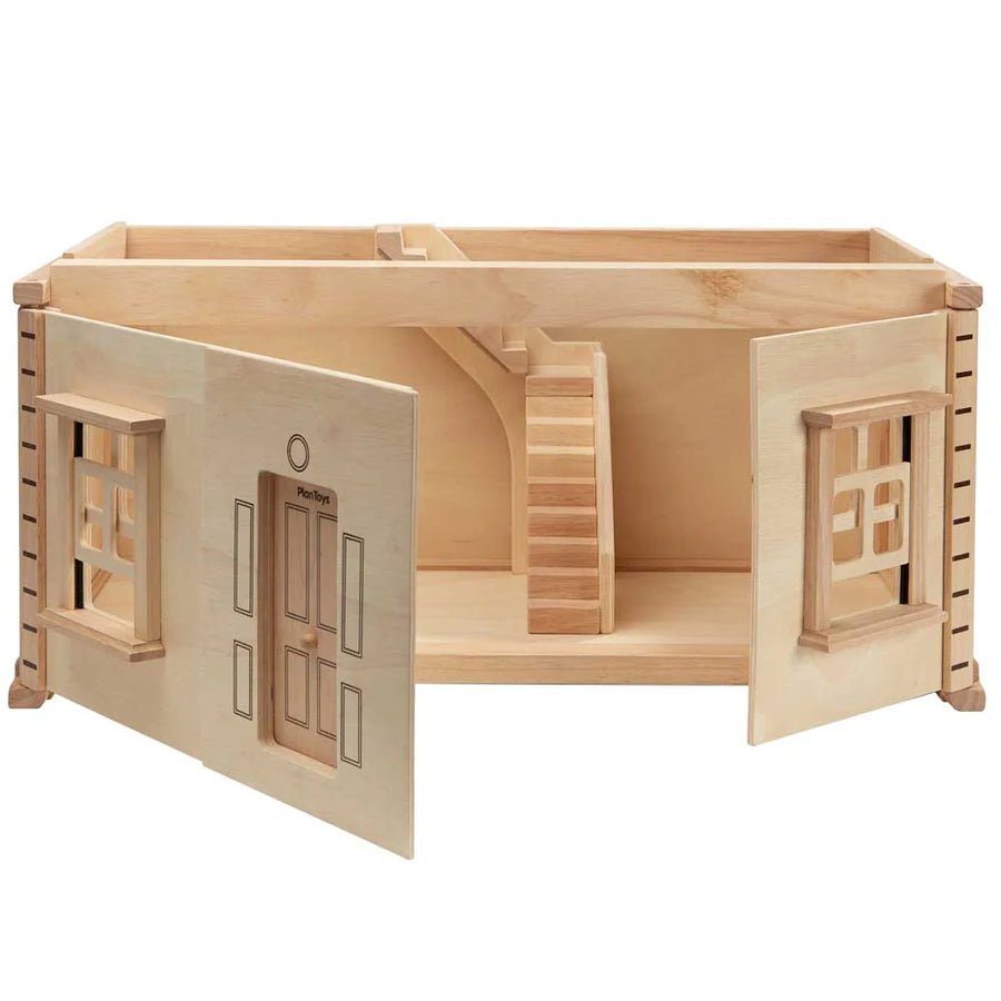 Wooden toy house with open doors on a white background